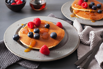 pancakes with blueberry raspberry honey and jam for breakfast