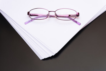 Mock up, a pack of white paper with glasses