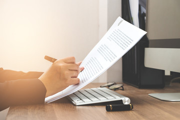 Business woman reading document paper on working table