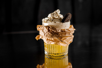Fresh sweet cocktail with whipped cream decorated with chocolate cookie