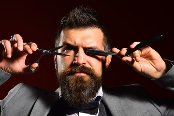 Businessman with strict face on dark red background.