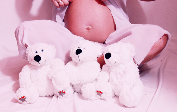 Pregnant woman holding a Teddy bear