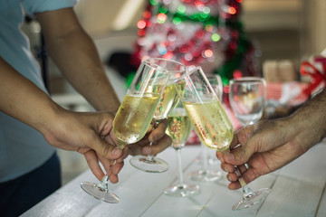people holding glass of champaign in Christmas celebration.