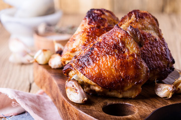 Roast chicken thighs on cutting board