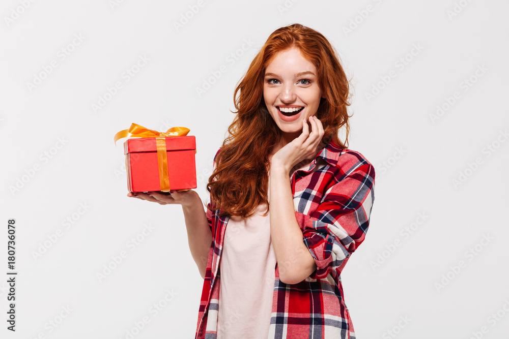 Sticker Image of Happy ginger woman in shirt holding gift box