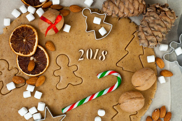 Christmas baking. Ginger dough for gingerbread, gingerbread men, stars, Christmas trees, dry orange slice, spices cinnamon