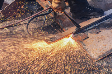 Worker cut the steel with fuel gas at factory.Close-up shoot