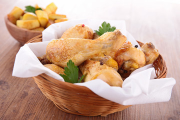 fried chicken leg and potatoes