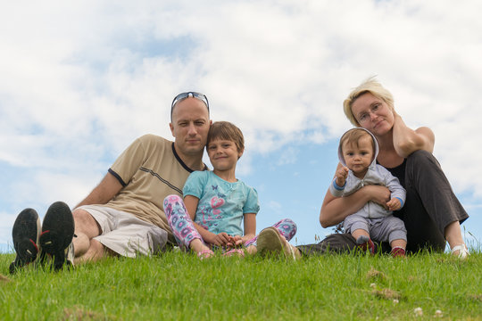 Happy family sitting on the grass