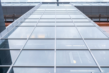 Close-up multi-storey office building with mirror windows. Lower angle shot.