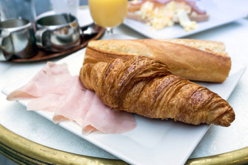 Breakfast with coffee and croissants on table