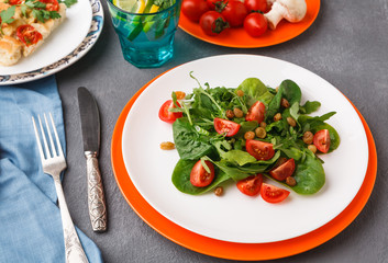 Eating healthy food on gray background.