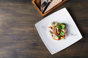 Salad with octopus and vegetables top view