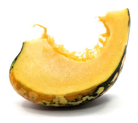One spotty green yellow pumpkin slice with seeds isolated on white background.