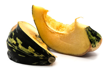 Two spotty green yellow pumpkin slices with seeds isolated on white background.