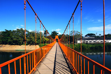 Orange steel bridge across on the river and mountain at countryside of Vangvieng,Laos