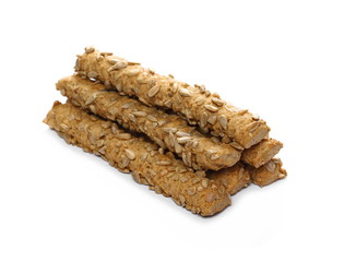 Integral bread sticks with sunflower seeds isolated on white background