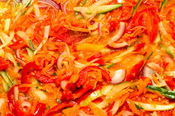 The process of cooking vegetable stew. Macro photography, close-up. Different vegetables. Colorful. Stewing in a frying pan.