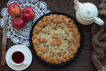 Fresh pastry apple pie on wooden table with hot drink tea on background. Homemade cake Thanksgiving. Village cuisine Rustic Food Cake concept. Holiday dinner with sweets