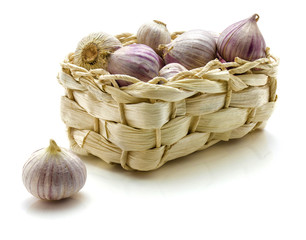 Solo garlic in straw basket isolated on white background single clove.