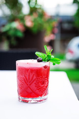 Cocktail in a Glass, Blackberry, Blueberry, Ice and Mint Leaves, Vertical View