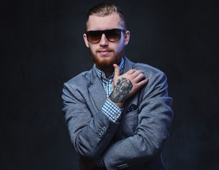 A man dressed in a suit and sunglasses.