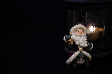 Beautiful christmas composition with  candle and toy Santa