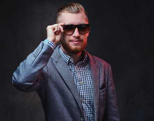 A man dressed in a suit and sunglasses.