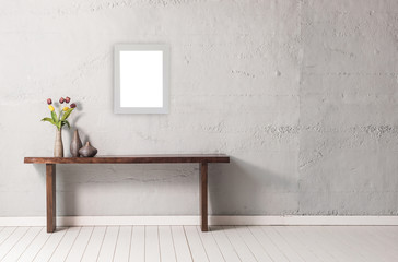 modern decorative coffee table with flowers and frame in front of the grey wall background