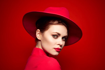 dramatic woman in a red hat on a red background