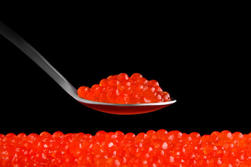 Fresh red caviar on a black background