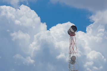 Fototapeta na wymiar Communication Tower with antenna and satellite dish telecom network on blue sky background.