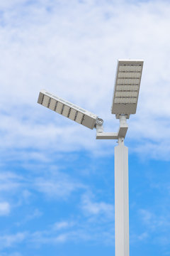 LED street light pole on blue sky with cloud
