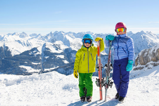 Smiling children enjoying winter vacations in mountains . Ski,Sun, Snow and Fun.