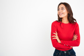 Pretty young happy woman standing with arms crossed