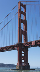 Vertical section of the suspension and view of the south tower from the boat, of the iconic Golden Gate Bridge, San Francisco, California, USA