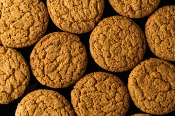 pattern of oatmeal cookies isolated on a black background