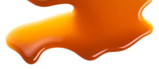 Sweet caramel sauce isolated on white background close up. Golden Butterscotch toffee caramel liquid . - obrazy, fototapety, plakaty