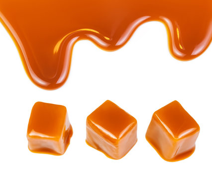 Caramel candies and caramel sauce isolated on a white background. Golden Butterscotch toffee candy