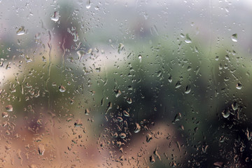 Water drops on glass. A blurred background of nature. Shallow depth of field.