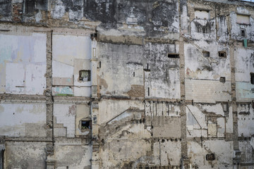 facade of an damaged abandoned apartment wall