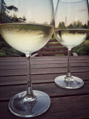 wine glasses on a wooden table at garden