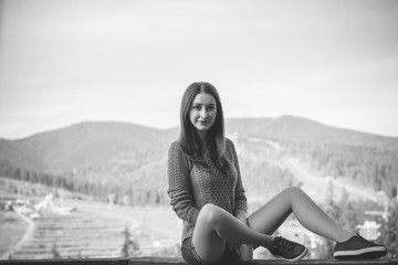 Naklejka na ściany i meble Beautiful and harmonious morning on vacation in the mountains. A girl enjoying a day off with a cup of coffee. Beautiful landscapes and views for relaxing the soul and body. A healthy lifestyle