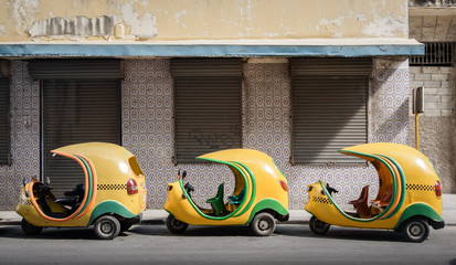 Small cuban coco taxis in line