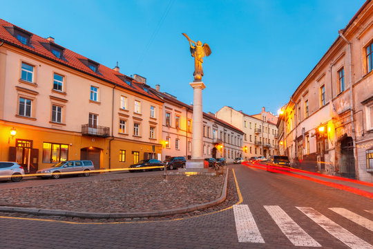 Uzupis Angel, statue of an angel blowing a trumpet in the main square, symbol quarter of an independent republic Uzupis, during evening blue hour, Vilnius, Lithuania, Baltic states.