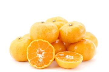 Pile of many orange fruits on white background, side view, have some have some piece sliced can see seed inside.