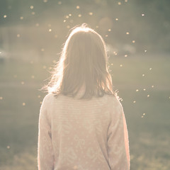 Rear view of unkempt teenage girl, girl thinks, disorderly insects flying over her head as thoughts