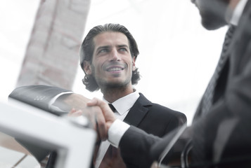 confident handshake colleagues in the office