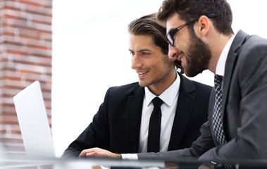 Fototapeta premium Male executives in office, looking at computer
