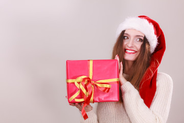 Woman holding gift box. Christmas time